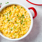 Mac and cheese in red pot, top view. Traditional American food.